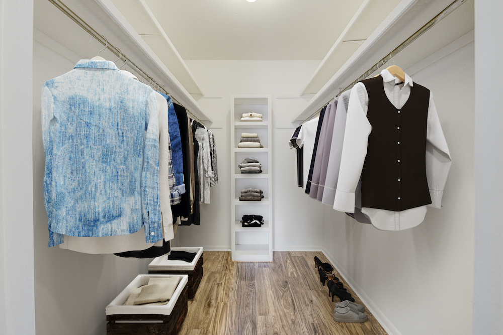 closet with built-in shelving and two hanging racks
